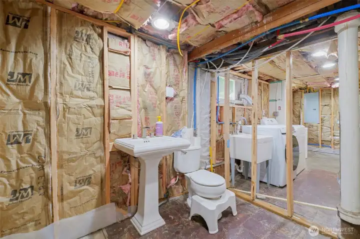 Half bath is hooked up but unfinished space - all flooring, insulation and drywall needed to finish space comes with home