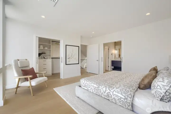 The Primary bedroom is spacious, with synchronized double doors to the bath and walk-in closet.