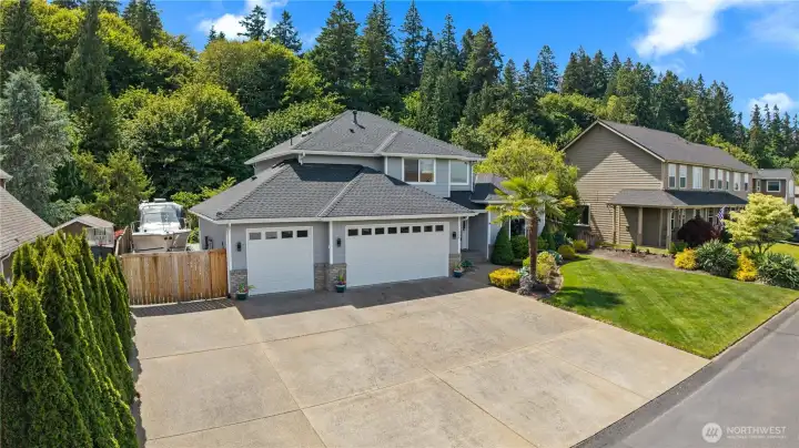 The fully finished 3-Car Garage plus RV & Boat Driveway provides ample space for vehicles, hobbies, and storage.
