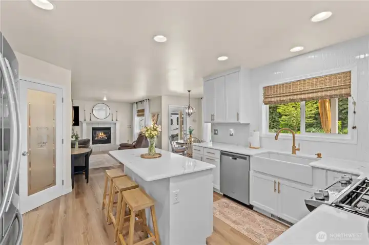 View toward Dining Nook and Family Room with Gas Fireplace. Notice you can fit 3 stools at the generously sized island!