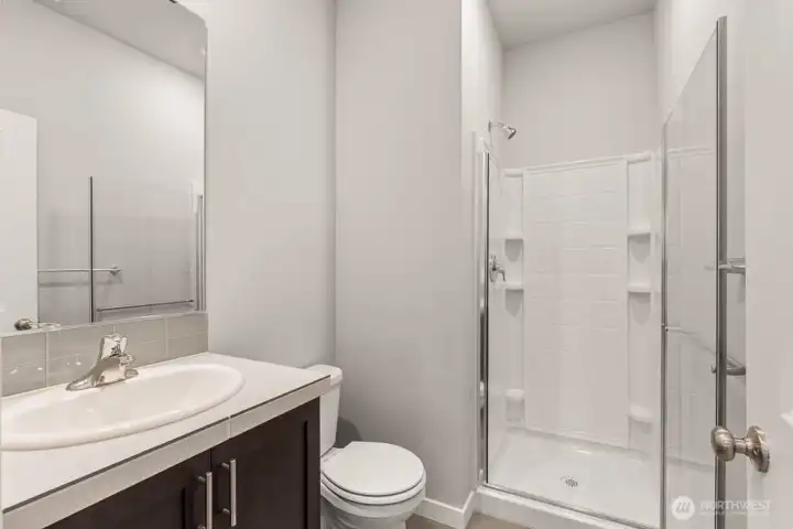 Main floor 3/4 bath, perfect for guests. Photos are for representational purposes only. Colors and options may vary.