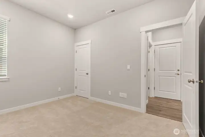 Bedroom on main floor. Photos are for representational purposes only. Colors and options may vary.