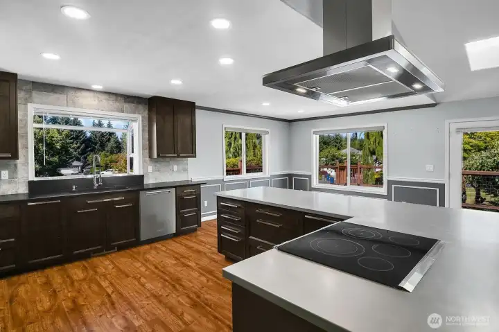 Quartz countertops complement the oversized stainless-steel island, creating exceptional prep space and ample storage space. Quartz countertops complement the oversized stainless-steel island, creating exceptional prep space and ample storage space.