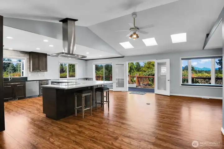 One of the home's standout features is its abundance of natural light, with expansive picture windows and multiple skylights creating a bright, open, and inviting atmosphere throughout. One of the home's standout features is its abundance of natural light, with expansive picture windows and multiple skylights creating a bright, open, and inviting atmosphere throughout.