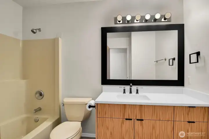 The updated main bathroom features a stylish new vanity, modern sink, and countertop. The updated main bathroom features a stylish new vanity, modern sink, and countertop.