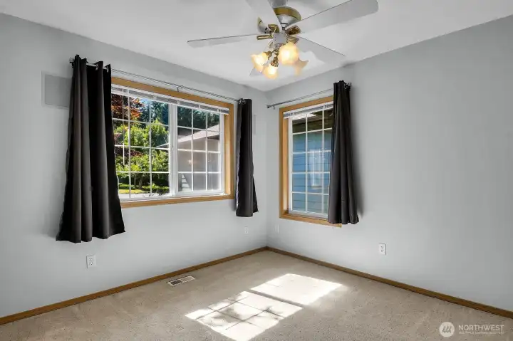 The second bedroom is filled with natural light, creating a bright, welcoming space. The second bedroom is filled with natural light, creating a bright, welcoming space.