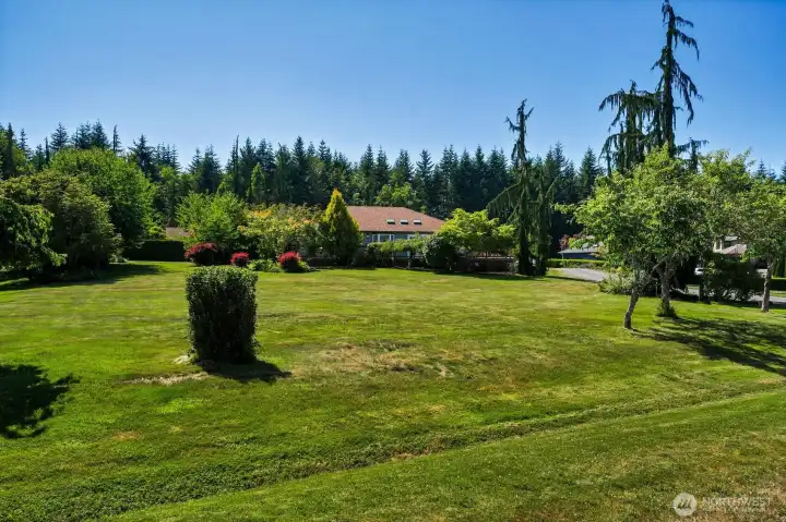 The rear of the home showcases the expansive property, with a spacious fenced dog run (not pictured) offering a secure and convenient space for pets. The rear of the home showcases the expansive property, with a spacious fenced dog run (not pictured) offering a secure and convenient space for pets.