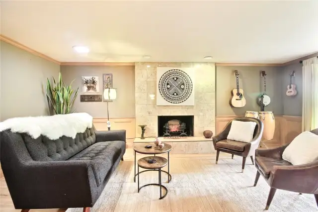 The formal living room has a charming fireplace, overlooks front patio.