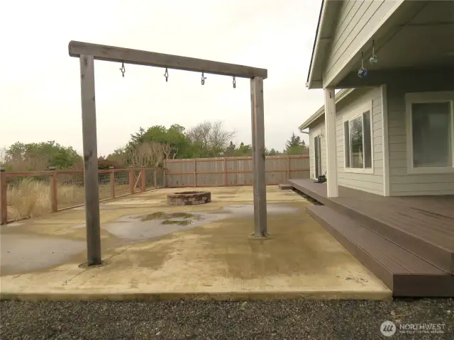 VIEW OF THE FENCED BACK YARD WITH PATIO AND SWINGS PLUS EASY CARE YARD!
