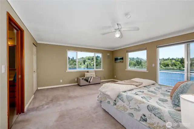 Spacious Primary bedroom has private balcony, great views,walk-in closet, bath ensuite, ceiling fan.