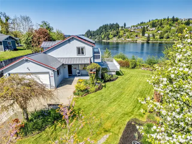 Nestled on .57 acres of manicured grounds, this waterfront and impressive water view home will delight!