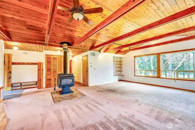 Another view of the Living Room with the entrance on the left and hallway to the bedrooms just to the right of the wood stove.