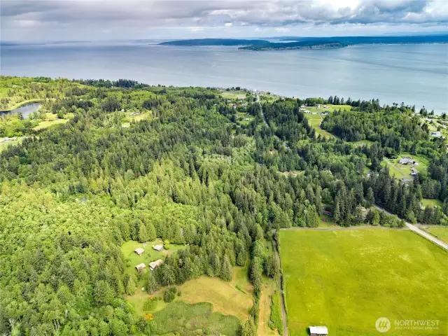 Looking due north, Hansville village is near the center top of the photo.  Buck lake to the left, Skunk Bay just beyond and past that the shipping lanes then Whidbey Island (Double Bluff in the center and Useless Bay on the right.