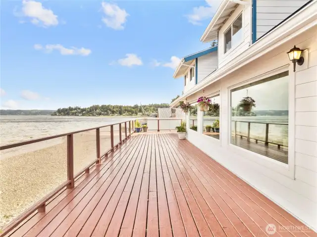 Expansive deck runs the entire length of the house, then wraps around either side, for the ultimate enteraining space.