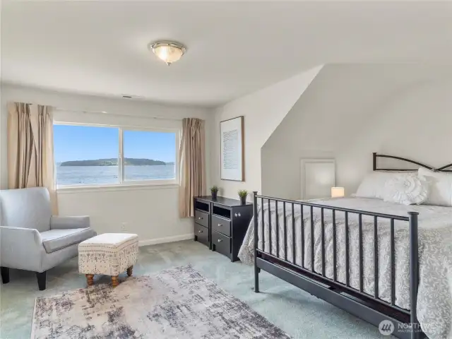 Bedroom number two is on the upper level, overlooking the expansive views. In addition to the closet, there's a large storage space to the left of the bed.