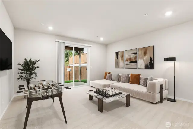 Daylight basement rec room with covered patio. Photo's are for representational purposes only. Colors and finishes may differ.