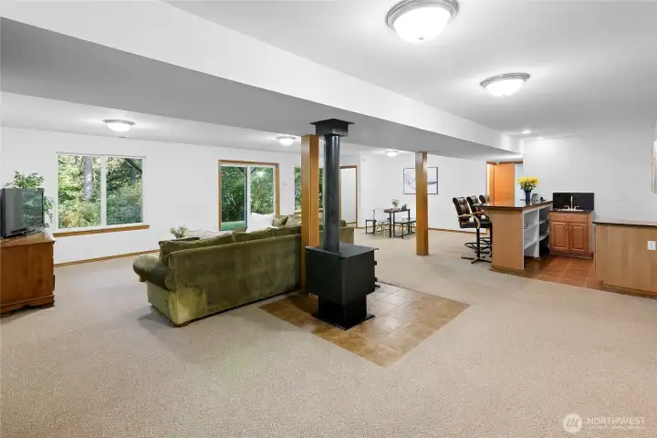 Wood burning stove, wet bar plumbed for frig.w/icemaker, and E-Z patio and yard access.  Bedroom #4 is behind the door at the far end.