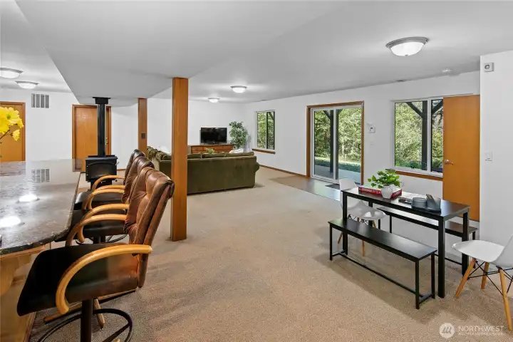 Doors at the far end are utilities and storage area, and lower level heated garage / shop.