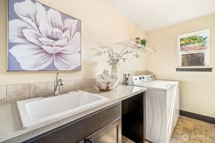 Upstairs laundry room with built in utility sink