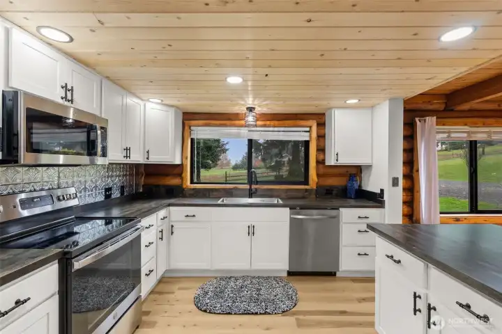 Updated kitchen with picture window above the sink.