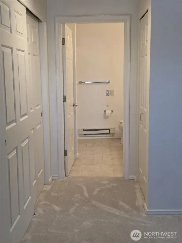 Primary bathroom.  Closets are on either side of the hallway to this bath.