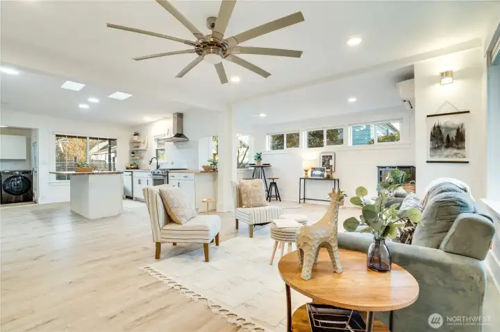 Step inside to a bright, open floor plan featuring low-maintenance luxury vinyl flooring, recessed lighting, skylights, and abundant windows for beautiful natural light throughout.