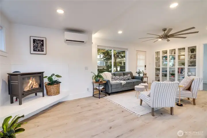 A large living room window fills the space with warm, natural sunlight.