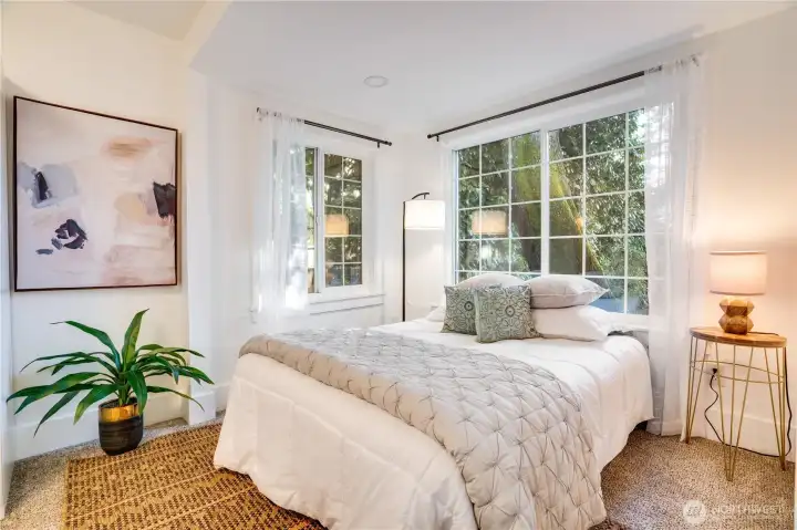 The primary bedroom offers space for a queen bed, large windows, and freshly cleaned carpet—ready for easy move-in!