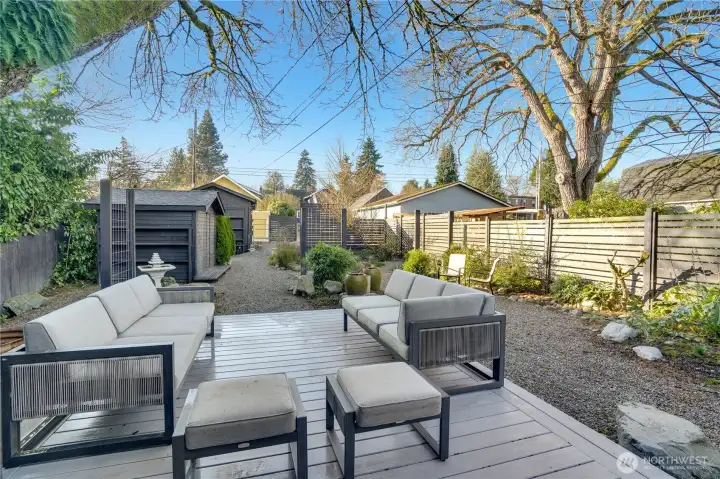 Bright blue skies stretch over your outdoor living space. These photos were taken in the morning, but the afternoon sun floods this area, making it ideal for summer gatherings and relaxed dinners.