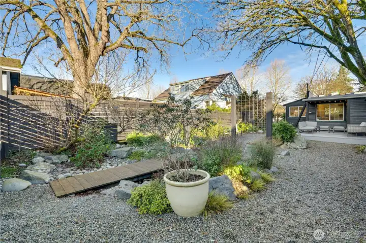 Mature trees surround the lot, providing privacy, natural beauty, and cooling shade during the summer months.