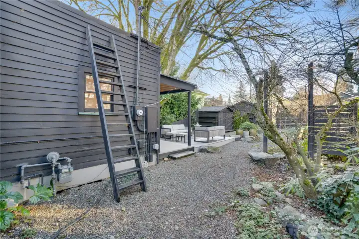 A ladder leads to a rooftop deck for additional outdoor enjoyment. The roof and gutters were recently cleaned.
