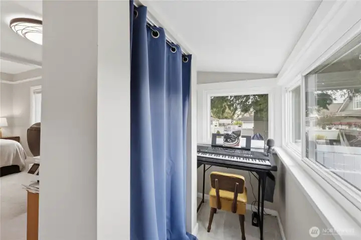 On the other side of the wall is a mini room used as a music room.