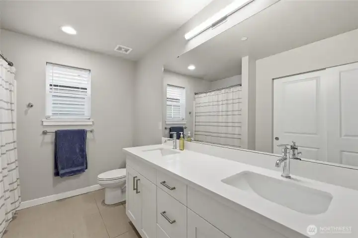 Main Bath with double sinks large bathroom storage closet.