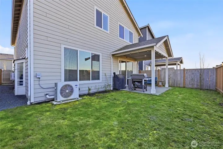 Fully fenced back and side yard with covered sitting/BBQ area