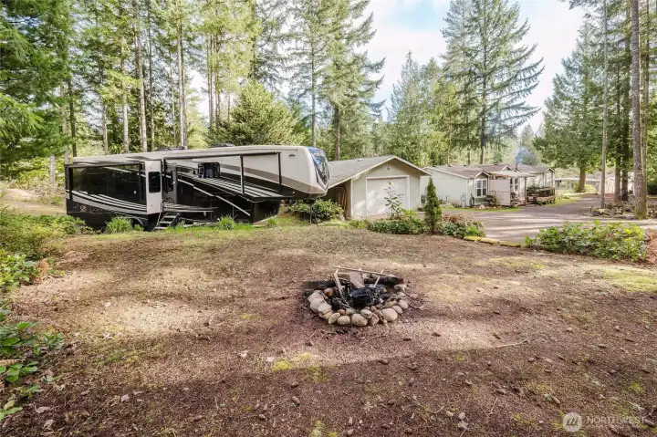 Taken from the fire pit on the west side of property. Looking to RV parking, Garage, home on acreage.