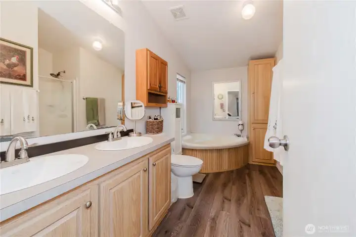 Primary bathroom with soaking tub, double vanity and separate shower.