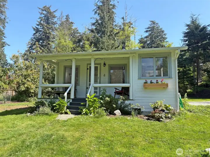 Sweet 1928 cottage with great covered front porch to enjoy your beautiful setting.