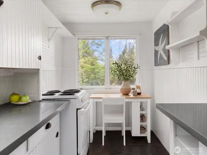 A cottage kitchen if there ever was one!  The nook area could be a kitchen eating space, or used as a desk area instead.  The desk and chair and tabletop items are virtually staged.