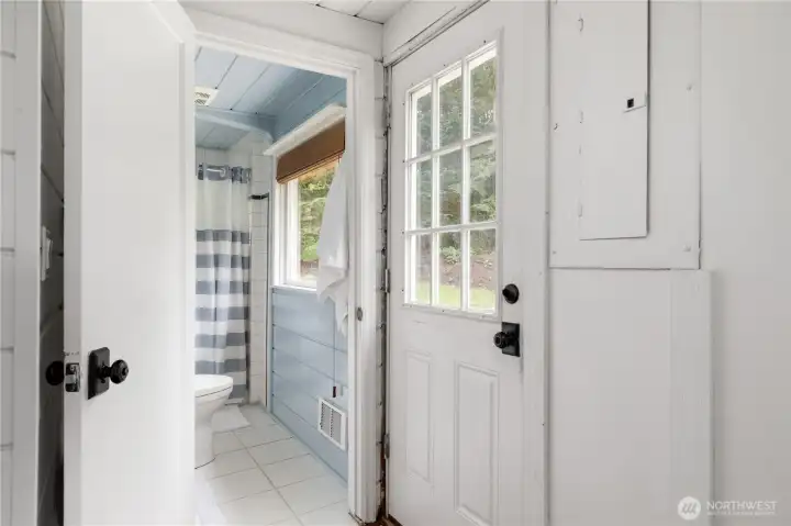 The back door entry between the bathroom and the kitchen area.