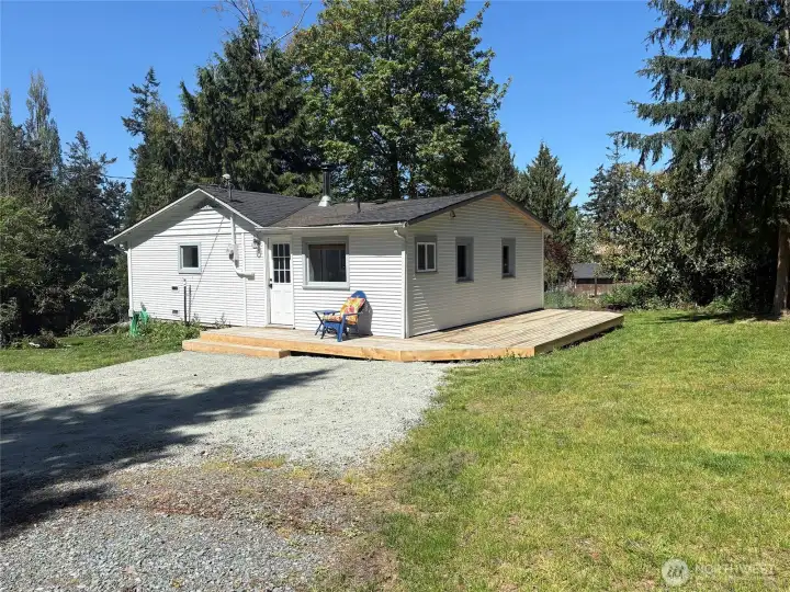 The kitchen side and bedroom sides of the house have a deck area overlooking the backyard.