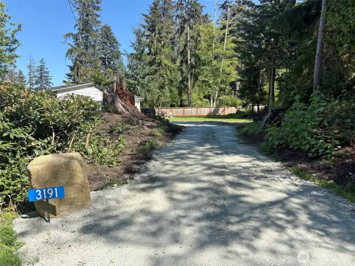 The driveway is new, and freshly graveled.