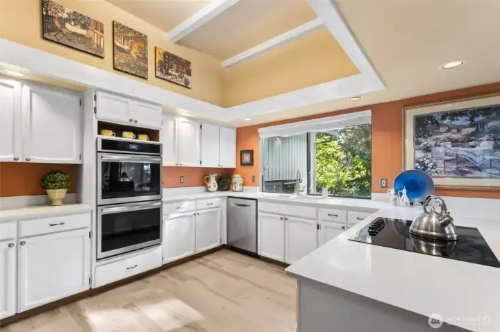 White cabinets and southern exposure window provide light airy feel.