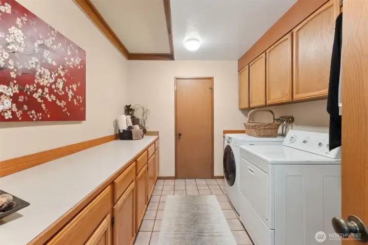 Lower level laundry has lots of storage and overhead access to above the ceiling large storage room. Houses hot water heater.