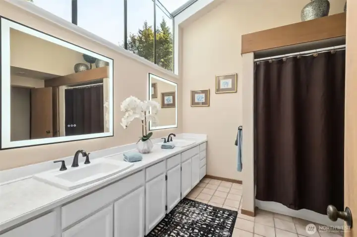 Hallway bathroom with wall/ceiling windows for great morning light.