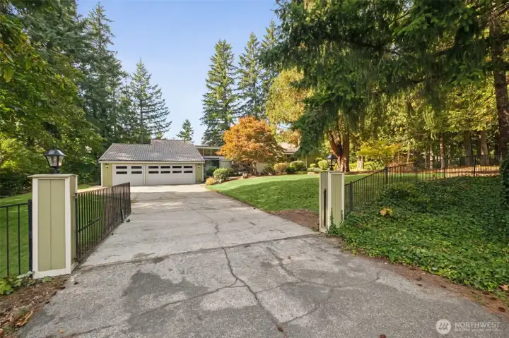 gated drive partially fences yard for pets.