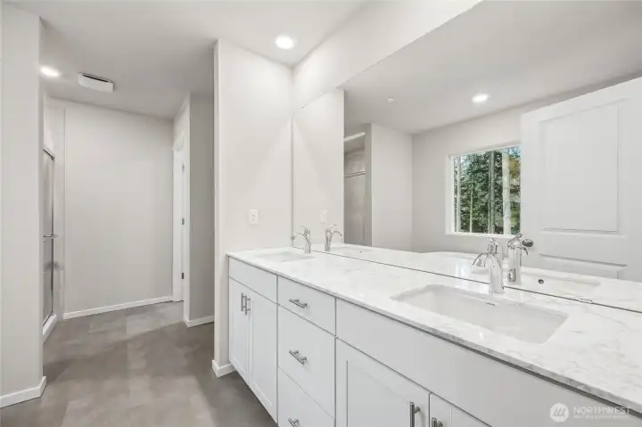 Primary bathroom with slab quartz counters and dual vanities. Picture for representational purposes only, colors and features may vary. Primary bathroom with slab quartz counters and dual vanities. Picture for representational purposes only, colors and features may vary.