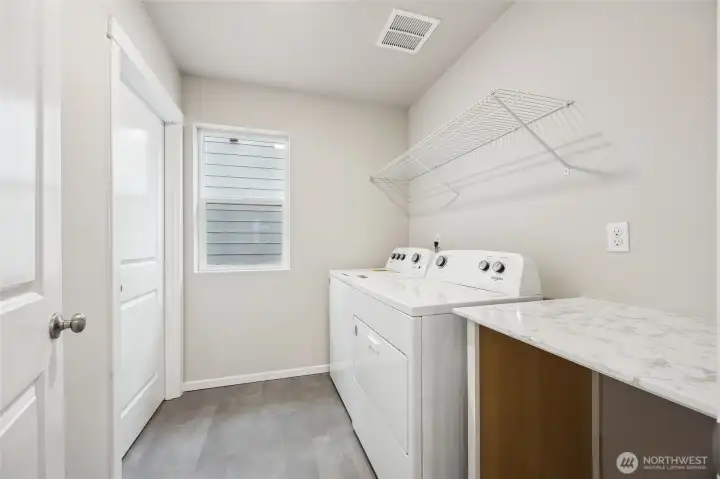 Convenient upstairs laundry room with folding table. Picture for representational purposes only, colors and features may vary. Convenient upstairs laundry room with folding table. Picture for representational purposes only, colors and features may vary.