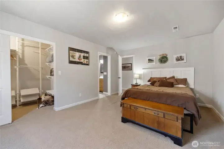 main floor primary bedroom with en suite, propane fireplace, and walk-in closet