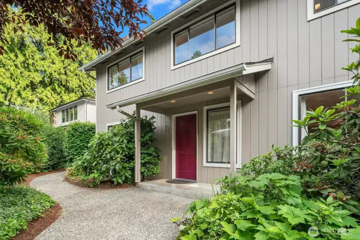 A landscaped walkway & covered porch welcome you to this classic 2-story home.