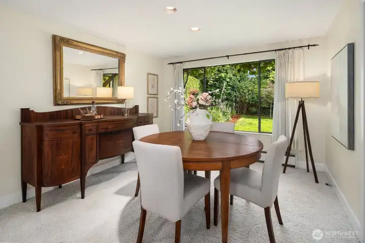 The formal dining area enjoys lovely backyard views.